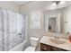 Functional bathroom with a shower-tub combo, neutral tones, and a window for ventilation and natural light at 4014 Stockbrook Dr, Charlotte, NC 28215