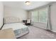 Bright bedroom featuring a cozy bed, study desk, and natural light from the large windows at 4014 Stockbrook Dr, Charlotte, NC 28215