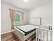 Bright bedroom with a queen size bed, neutral walls, and ample natural light streaming through the window at 4014 Stockbrook Dr, Charlotte, NC 28215
