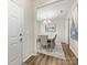 Elegant dining room with a modern chandelier, dining table, and view to the hallway at 4014 Stockbrook Dr, Charlotte, NC 28215