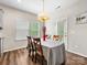 Cozy dining area with natural light, featuring a modern chandelier and access to the backyard at 4014 Stockbrook Dr, Charlotte, NC 28215