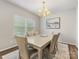 Bright dining room showcasing a modern chandelier, dining table, and a large window at 4014 Stockbrook Dr, Charlotte, NC 28215