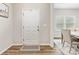 Bright entryway with wood floors, a front door, and a view into the dining area at 4014 Stockbrook Dr, Charlotte, NC 28215