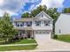 Charming two-story home with stone accents, a two-car garage, and a well-manicured front lawn at 4014 Stockbrook Dr, Charlotte, NC 28215