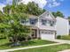 Beautiful two-story home with stone accents, two-car garage, and a lush green lawn at 4014 Stockbrook Dr, Charlotte, NC 28215