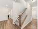 Hallway with wood flooring and a carpeted staircase leading upstairs, connecting the home's different levels at 4014 Stockbrook Dr, Charlotte, NC 28215
