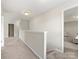 Upstairs hallway with neutral carpet, leading to different rooms and providing a seamless transition between spaces at 4014 Stockbrook Dr, Charlotte, NC 28215