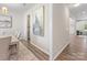 Hallway with hardwood floors and view into dining room and another living area at 4014 Stockbrook Dr, Charlotte, NC 28215