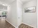 Hallway with hardwood floors and view into living room and stairs at 4014 Stockbrook Dr, Charlotte, NC 28215