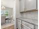Elegant kitchen detail with granite countertops, subway tile backsplash, and modern gray cabinetry at 4014 Stockbrook Dr, Charlotte, NC 28215