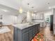 Bright open kitchen flows seamlessly into the living area, with a large island and bar stool seating at 4014 Stockbrook Dr, Charlotte, NC 28215