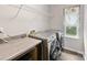 Well-equipped laundry room boasts modern washer/dryer and counter space, ensuring efficient chores at 4014 Stockbrook Dr, Charlotte, NC 28215