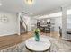 Open-concept living room with a view of the kitchen, dining area, and staircase, enhancing the home's flow and connectivity at 4014 Stockbrook Dr, Charlotte, NC 28215