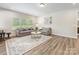 Bright living room with a large patterned rug, recessed lighting, and large windows offering ample natural light at 4014 Stockbrook Dr, Charlotte, NC 28215