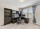 Functional home office featuring a built-in desk, shelving, and natural light at 4014 Stockbrook Dr, Charlotte, NC 28215