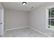 This bedroom features neutral walls, tiled floor, and a bright window for natural light at 409 Guiness Pl, Rock Hill, SC 29730