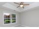 Bedroom with tray ceiling, ceiling fan, and a large window overlooking trees at 409 Guiness Pl, Rock Hill, SC 29730