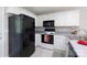 Functional kitchen with white cabinets and black appliances at 409 Guiness Pl, Rock Hill, SC 29730