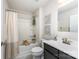 Cozy bathroom featuring a tub with a shower curtain, a toilet, and a vanity with a dark cabinet at 4227 Mackinnon Dr, Charlotte, NC 28214