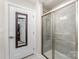 Bright bathroom featuring a glass-enclosed shower with gray tile and a door to the closet at 4227 Mackinnon Dr, Charlotte, NC 28214