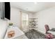 Cozy bedroom with a gray rug, a white desk, modern shelving, and a bright window at 4227 Mackinnon Dr, Charlotte, NC 28214