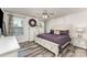 Comfortable bedroom with a ceiling fan, two windows, and a large bed with a purple duvet at 4227 Mackinnon Dr, Charlotte, NC 28214