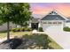 Charming single-story home featuring a two-car garage, well-manicured lawn, and beautiful landscaping at 4227 Mackinnon Dr, Charlotte, NC 28214