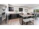 Modern kitchen features dark cabinets, granite countertops, stainless steel appliances, and an island with bar seating at 4227 Mackinnon Dr, Charlotte, NC 28214