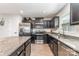 Modern kitchen featuring stainless steel appliances, dark cabinets, and granite countertops at 4227 Mackinnon Dr, Charlotte, NC 28214