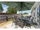 Outdoor patio with a large umbrella, a dining table with six chairs, and a grill at 4227 Mackinnon Dr, Charlotte, NC 28214
