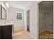 Bathroom with a dark wood vanity, window, and hardwood floors at 4911 Rivergreen Ln, Charlotte, NC 28227