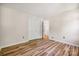 Neutral room with hardwood floors, closet, and a door that leads to the stairway at 4911 Rivergreen Ln, Charlotte, NC 28227