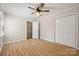 Bedroom featuring hardwood floors, a ceiling fan with lights, closet and stairway at 4911 Rivergreen Ln, Charlotte, NC 28227