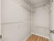 Walk-in closet with wire shelving and hardwood floors at 4911 Rivergreen Ln, Charlotte, NC 28227
