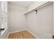 Walk-in closet with hardwood floors and white shelving at 4911 Rivergreen Ln, Charlotte, NC 28227