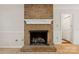 Rustic brick fireplace with white mantle and wood floors at 4911 Rivergreen Ln, Charlotte, NC 28227