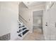 Bright foyer with white walls, staircase, tile floor, and view of living room at 4911 Rivergreen Ln, Charlotte, NC 28227
