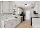 Bright kitchen featuring white cabinets and stainless steel appliances at 4911 Rivergreen Ln, Charlotte, NC 28227