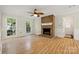 Bright living room with fireplace, hardwood floors, and lots of natural light at 4911 Rivergreen Ln, Charlotte, NC 28227