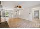 Bright, open living room featuring wood floors and views of the kitchen and access to outdoor living space at 4911 Rivergreen Ln, Charlotte, NC 28227