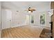 Bright living room showcasing wood floors, brick fireplace, and windows with green views at 4911 Rivergreen Ln, Charlotte, NC 28227