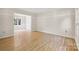 Bright living room featuring hardwood floors and white molding detail at 4911 Rivergreen Ln, Charlotte, NC 28227