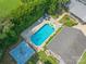 Aerial view of a backyard pool with clear blue water, lounge chairs, and mature landscaping at 4911 Rivergreen Ln, Charlotte, NC 28227