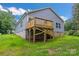 Backyard with a new deck, green grass, and new construction at 5185 Grand Canyon Rd, Concord, NC 28027