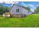 Exterior view showcasing the backyard, deck, and gray siding of the home at 5185 Grand Canyon Rd, Concord, NC 28027