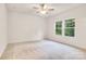 An airy bedroom featuring a ceiling fan and two large windows providing natural light at 5185 Grand Canyon Rd, Concord, NC 28027