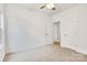 A simple bedroom with carpeted floor and a ceiling fan with lights at 5185 Grand Canyon Rd, Concord, NC 28027