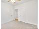 A simple bedroom with carpeted floor and a ceiling fan with lights at 5185 Grand Canyon Rd, Concord, NC 28027
