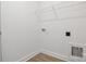 A simple, efficient laundry room featuring a wire rack shelf for storage solutions at 5185 Grand Canyon Rd, Concord, NC 28027