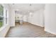 Bright and airy living room with hardwood floors and views into the kitchen area at 5185 Grand Canyon Rd, Concord, NC 28027